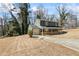 A blue house with a covered porch and a long driveway on a grassy hill at 801 Hemingway Rd, Stone Mountain, GA 30088