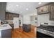 Open concept kitchen with stainless steel appliances, granite countertops and hardwood floors at 801 Hemingway Rd, Stone Mountain, GA 30088