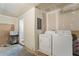 Laundry room featuring white washer and dryer, and unfinished drywall at 801 Hemingway Rd, Stone Mountain, GA 30088