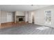 Open living room featuring neutral walls, stone fireplace, and a door to the backyard at 801 Hemingway Rd, Stone Mountain, GA 30088