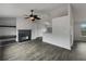 Living room features gray floors, ceiling fan and black fireplace at 10511 Tobano Trl, Jonesboro, GA 30238