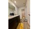 Well-lit bathroom showing plank flooring, and a vanity with granite countertop at 1367 Midnight Ride Ct, Hampton, GA 30228