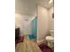 A bathroom featuring a vanity with a dark countertop, alongside a toilet and a shower with a decorative blue curtain at 1367 Midnight Ride Ct, Hampton, GA 30228
