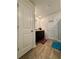 A bright bathroom includes a dark vanity and contrasting colorful mats, accessed through white paneled doors at 1367 Midnight Ride Ct, Hampton, GA 30228