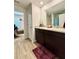Elegant bathroom featuring double sinks, granite counters, and dark wood cabinets at 1367 Midnight Ride Ct, Hampton, GA 30228