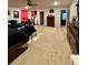 Expansive carpeted bedroom featuring a dark wood dresser, bed, workout machine and blue accents at 1367 Midnight Ride Ct, Hampton, GA 30228