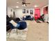 Large bedroom with a bed with dark wood frame, blue accent furniture, workout machine and neutral carpet at 1367 Midnight Ride Ct, Hampton, GA 30228