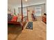 Bedroom boasts a four-poster bed, rocking chair, dresser, and natural light from windows at 1367 Midnight Ride Ct, Hampton, GA 30228