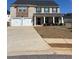Two-story home featuring a two-car garage, brick facade, and a covered front porch with stately columns at 1367 Midnight Ride Ct, Hampton, GA 30228