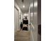 Hallway with hardwood floors and neutral walls leads to a bathroom vanity at 1367 Midnight Ride Ct, Hampton, GA 30228