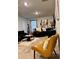 A comfortable living room showcases a modern design with a tan leather chair and contemporary décor at 1367 Midnight Ride Ct, Hampton, GA 30228