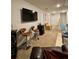 Spacious living room featuring wall-mounted tv and accent bar with barstool seating at 1367 Midnight Ride Ct, Hampton, GA 30228