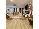 Open-concept living room with modern furniture, cozy seating, and an elegant decorative fireplace at 1367 Midnight Ride Ct, Hampton, GA 30228