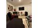 Relaxing living room with accent wall art, bar area, and wall-mounted television at 1367 Midnight Ride Ct, Hampton, GA 30228