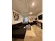 The living room is furnished with a dark sectional sofa and is accented with stylish elephant-themed artwork at 1367 Midnight Ride Ct, Hampton, GA 30228