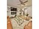 Cozy living room with leather sofas, fireplace, ceiling fan, and modern decor at 1367 Midnight Ride Ct, Hampton, GA 30228