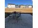 Close-up view of the concrete patio and outdoor seating in the backyard at 1367 Midnight Ride Ct, Hampton, GA 30228