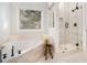 Bright bathroom with tub, separate glass shower, and neutral tile at 2869 Amesbury Nw, Kennesaw, GA 30144