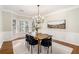 Dining room features a modern chandelier, large windows, neutral paint, and plenty of light at 2869 Amesbury Nw, Kennesaw, GA 30144