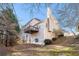 Beige two-story home featuring a wooden deck on the rear and a chimney under a blue sky at 2869 Amesbury Nw, Kennesaw, GA 30144