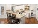 Eat-in kitchen with granite countertops, island seating, stainless appliances, and white cabinetry at 2869 Amesbury Nw, Kennesaw, GA 30144