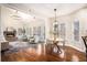 Open-concept living room with fireplace and vaulted ceilings adjacent to dining area and natural light at 2869 Amesbury Nw, Kennesaw, GA 30144