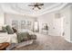 Spacious main bedroom with tray ceiling, plush carpet, and ample natural light at 2869 Amesbury Nw, Kennesaw, GA 30144