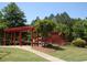 Community playground featuring play structure, picnic shelter, and mature landscaping at 2869 Amesbury Nw, Kennesaw, GA 30144