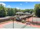Aerial view of tennis courts and recreational facilities surrounded by mature trees and landscaping at 2869 Amesbury Nw, Kennesaw, GA 30144