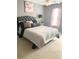 Cozy bedroom with a gray bed, soft pillows, and a calming color palette at 6706 Sunset Valley Cir, Rex, GA 30273
