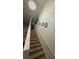 Carpeted staircase with white walls, white railing, and a modern chandelier at 6706 Sunset Valley Cir, Rex, GA 30273