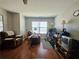 Carpeted room featuring a large window, a ceiling fan, a recliner and some furniture at 3835 Pleasant Oaks Dr, Lawrenceville, GA 30044