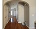 Inviting hallway with hardwood floors and an arched entryway at 3835 Pleasant Oaks Dr, Lawrenceville, GA 30044