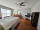 Bright main bedroom featuring hardwood floors and a ceiling fan at 3835 Pleasant Oaks Dr, Lawrenceville, GA 30044