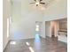 Open-concept living room with high ceilings, hardwood floors, and natural light streaming through the windows at 4853 Walkers Green, Mableton, GA 30126