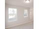 Bright bedroom featuring two windows offering natural light, and neutral carpeting at 4853 Walkers Green, Mableton, GA 30126