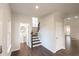 Inviting foyer with hardwood floors, half bath, staircase, and neutral paint scheme at 4853 Walkers Green, Mableton, GA 30126