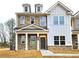 Charming two-story home with stone and siding, a covered porch, and well-manicured lawn at 4853 Walkers Green, Mableton, GA 30126