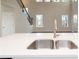 Close-up of modern sink with white quartz countertop and stainless steel faucet at 4853 Walkers Green, Mableton, GA 30126