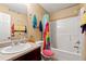 Cheerful bathroom features a shower-tub combo and vanity with countertop and fixtures at 4240 N Braves Cir, Douglasville, GA 30135