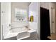 Bathroom with soaking tub and privacy glass window at 4240 N Braves Cir, Douglasville, GA 30135