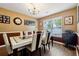 Dining room featuring a modern table set, hardwood floors, and natural light at 4240 N Braves Cir, Douglasville, GA 30135