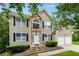 Beautiful two-story home featuring a stone facade and attached two-car garage at 4240 N Braves Cir, Douglasville, GA 30135