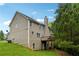 A serene yard with a wooded backdrop and a view of the charming back porch at 4240 N Braves Cir, Douglasville, GA 30135