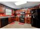 Well-equipped kitchen features wood cabinets, black appliances, and a sink with a window view at 4240 N Braves Cir, Douglasville, GA 30135