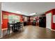 Spacious kitchen and dining area with dark cabinets, black appliances, and wood-look flooring at 4240 N Braves Cir, Douglasville, GA 30135