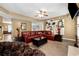 Inviting living room featuring a red leather sofa, stylish decor, and wood-look flooring at 4240 N Braves Cir, Douglasville, GA 30135