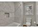 Updated bathroom with a shower/tub featuring marble tiling and a convenient built-in niche at 5810 Ripplestone Nw Ct, Acworth, GA 30101
