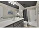 Bathroom featuring a large mirror, a vanity, and a shower with a gray curtain at 5810 Ripplestone Nw Ct, Acworth, GA 30101