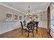 Dining room features hardwood floors, decorative molding, and an elegant chandelier at 5810 Ripplestone Nw Ct, Acworth, GA 30101